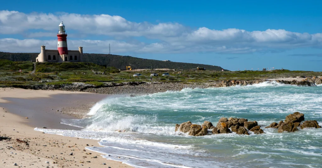 Lighthouse overlooking beach and ocean waves