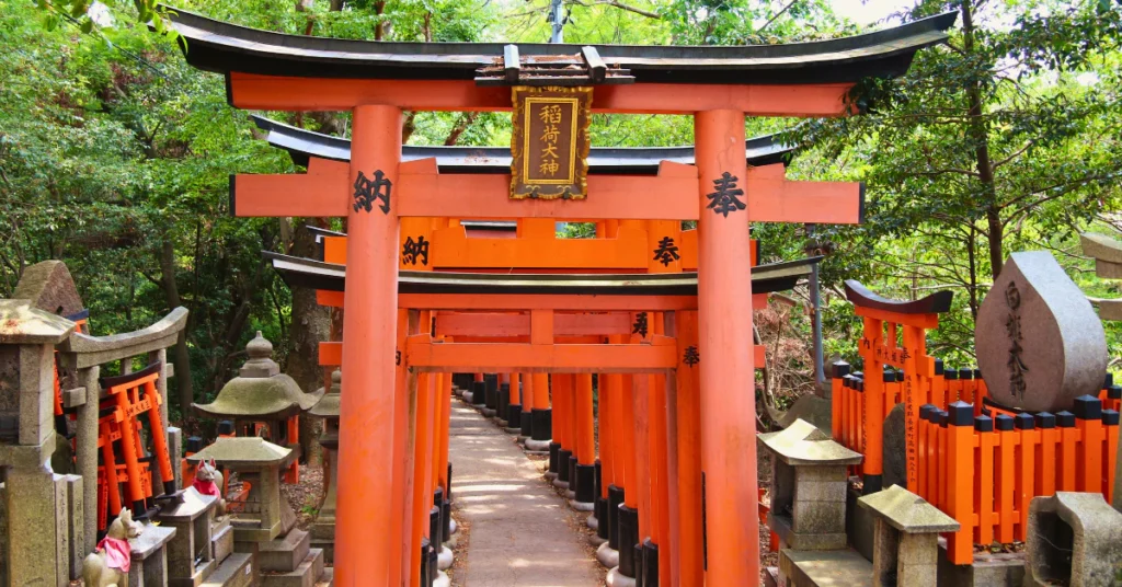 Rows of red torii gates lining a stone path at Fushimi Inari Shrine in Kyoto