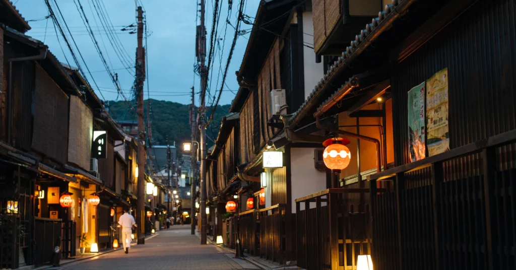 Quiet Gion lane lined with traditional wooden buildings in Kyoto at dusk