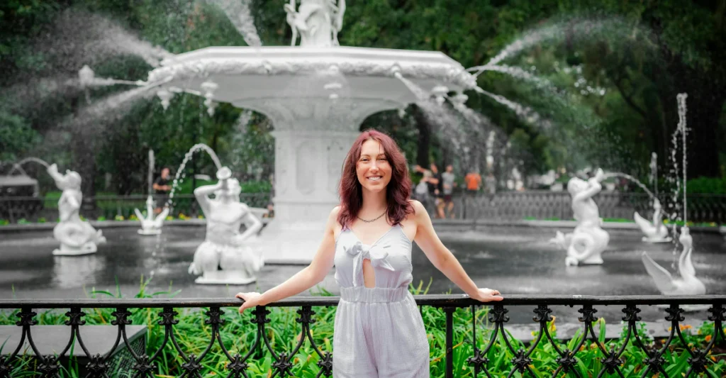 Woman standing in front of the cast-iron fountain at Forsyth Park in Savannah