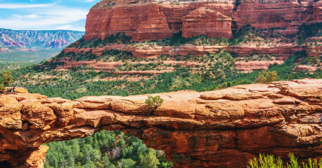 Scenic view of red rock buttes and green desert landscape in Sedona