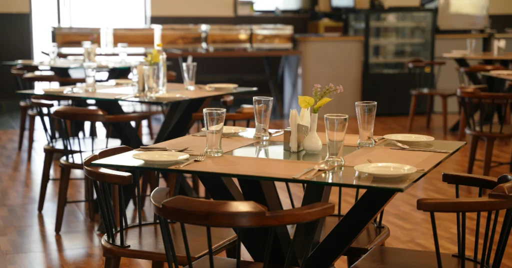 Cozy restaurant interior with wooden tables set for dining