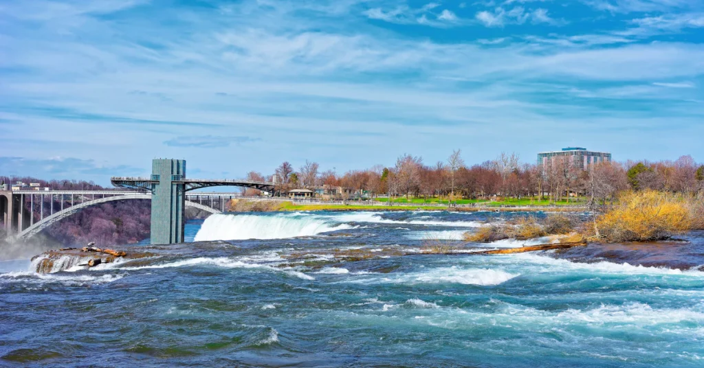 Niagara River and falls with autumn-colored trees along the shoreline