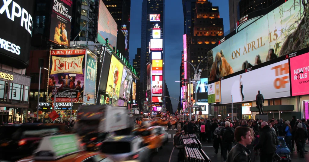 Times Square at night with bright billboards near Broadway theaters
