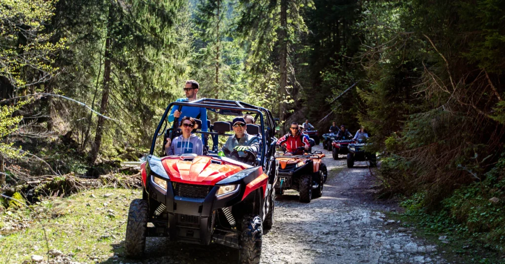 Group riding ATVs along a tropical forest trail