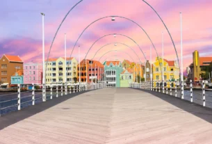 Queen Emma Bridge at sunset with colorful buildings of Willemstad in Curaçao