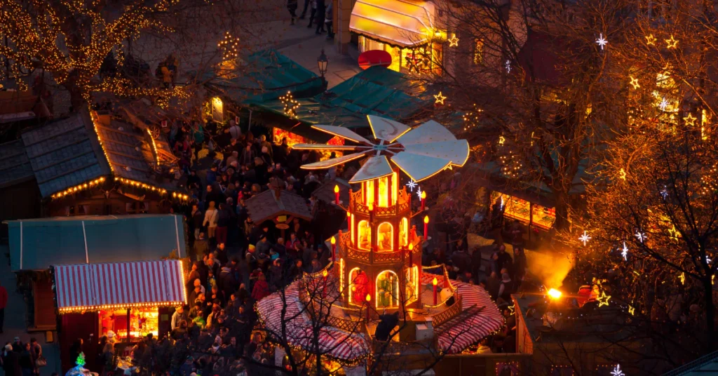Christmas market stalls and lights glowing at night in Munich