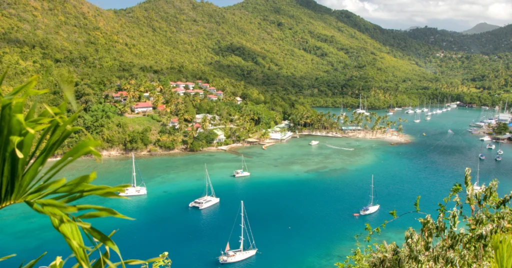 Turquoise bay with sailboats and green hills in St. Lucia