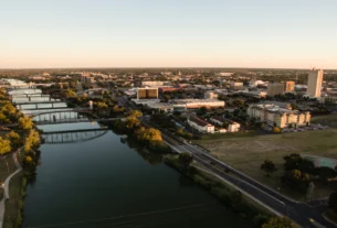 Aerial view of a river running through a city at sunset
