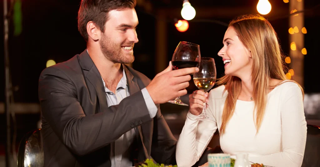 Couple toasting with glasses of wine at a restaurant dinner